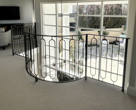 Custom black curved internal stair balustrade
