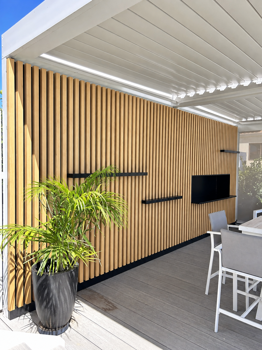 Timber-look aluminium batten feature wall with integrated shelves