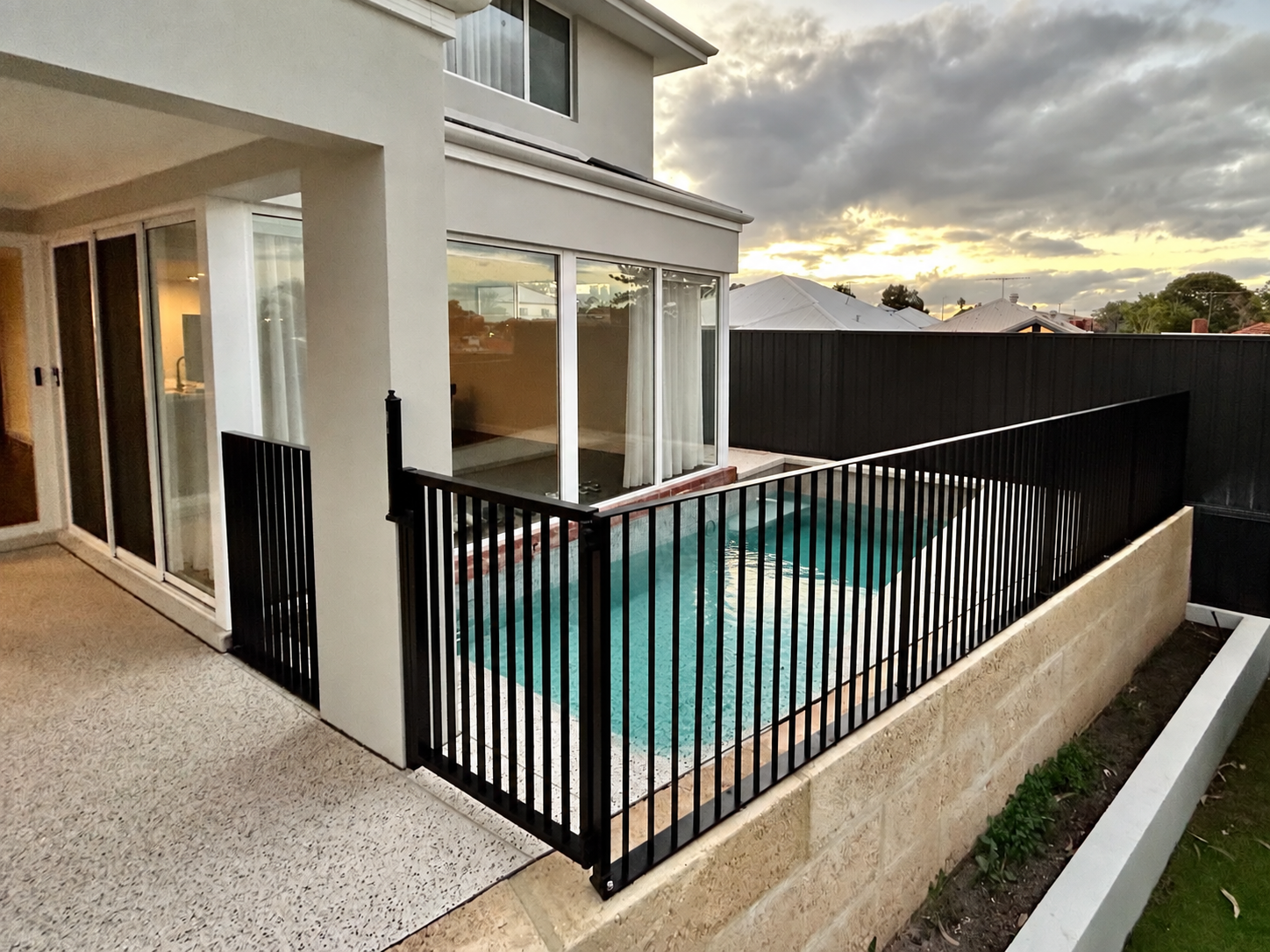 Black metal balustrade around a residential pool